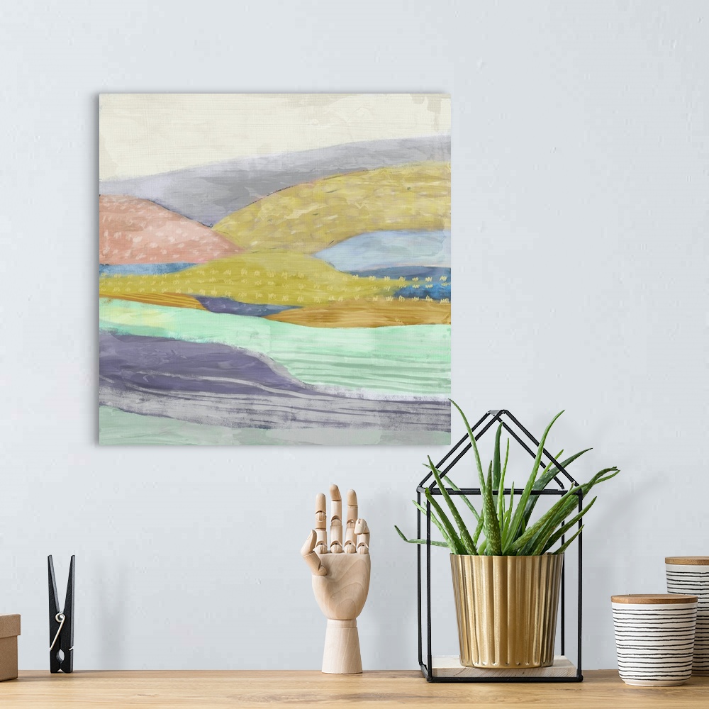 A bohemian room featuring Abstract painting of a multi-colored hilly landscape.