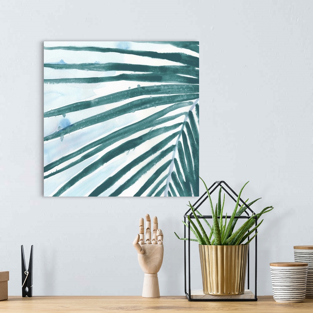 A bohemian room featuring Watercolor painting of a palm frond with teal leaves.