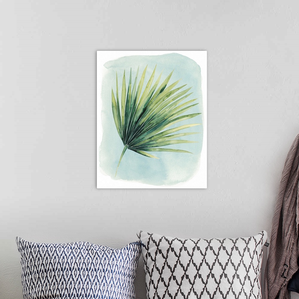 A bohemian room featuring Watercolor artwork of a broad green palm leaf on pale blue.