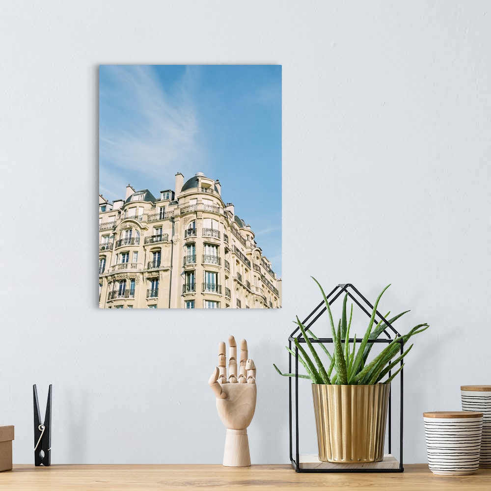 A bohemian room featuring Photograph of Paris apartments buildings beneath a blue sky.