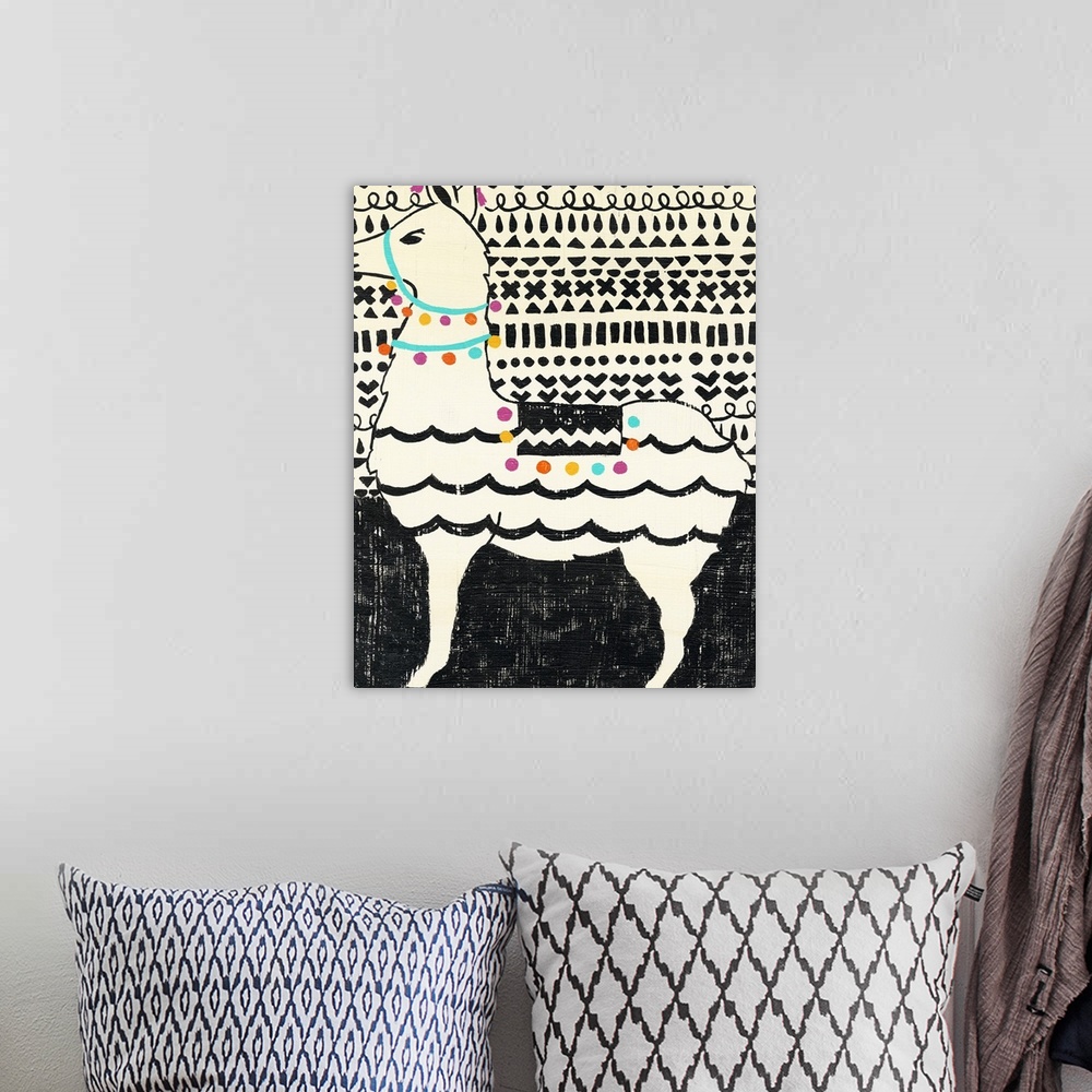 A bohemian room featuring Whimsical painting of a llama in black and white wearing colorful party decorations.