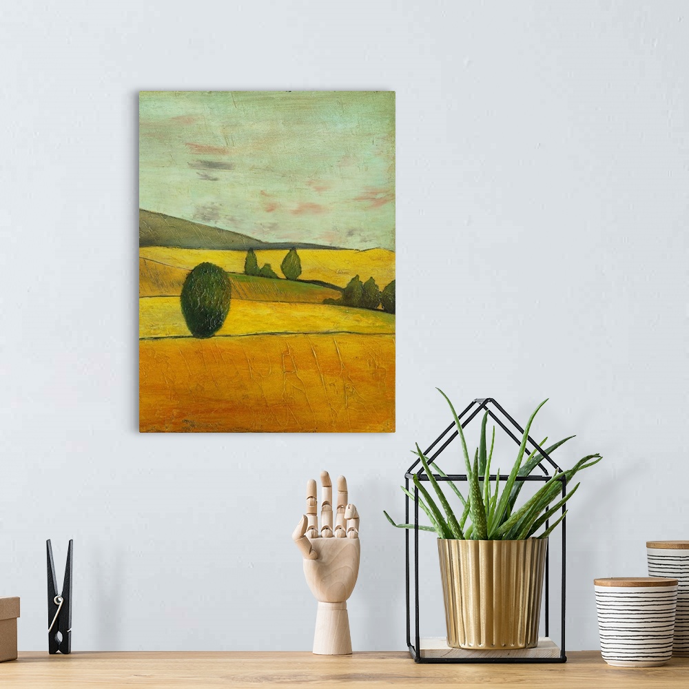 A bohemian room featuring Contemporary painting of a golden landscape of rolling countryside hills.