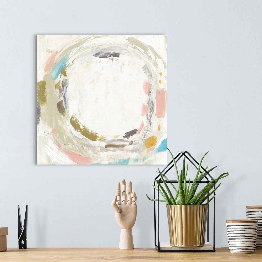 A bohemian room featuring Abstract painting of a circular shape of pastel pink, blue, and grey.