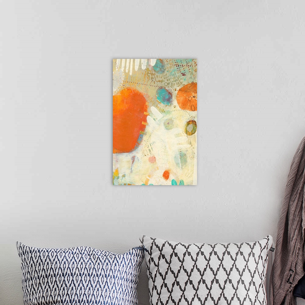 A bohemian room featuring Mod abstract artwork in bright orange, teal, and off-white.