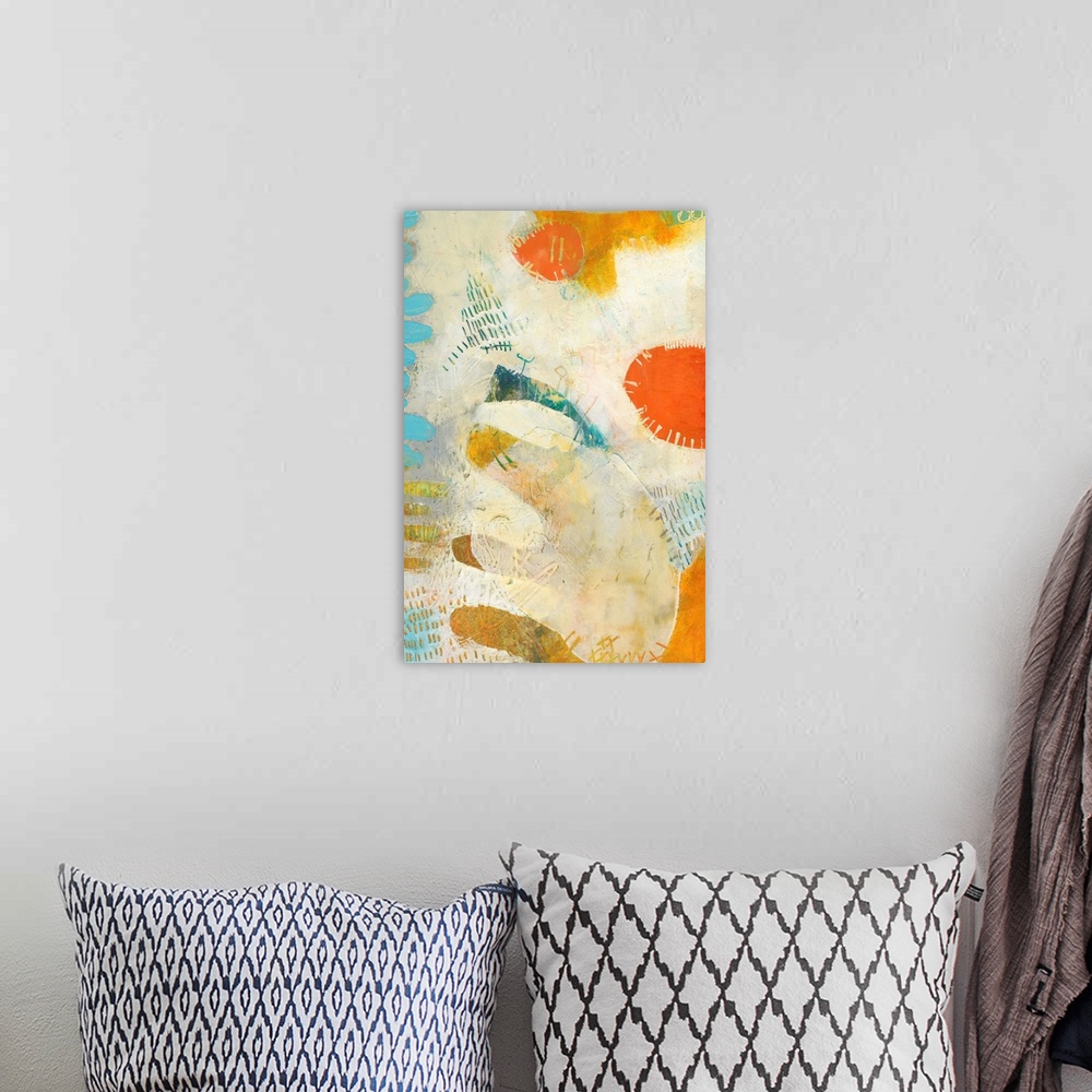 A bohemian room featuring Mod abstract artwork in bright orange, teal, and off-white.
