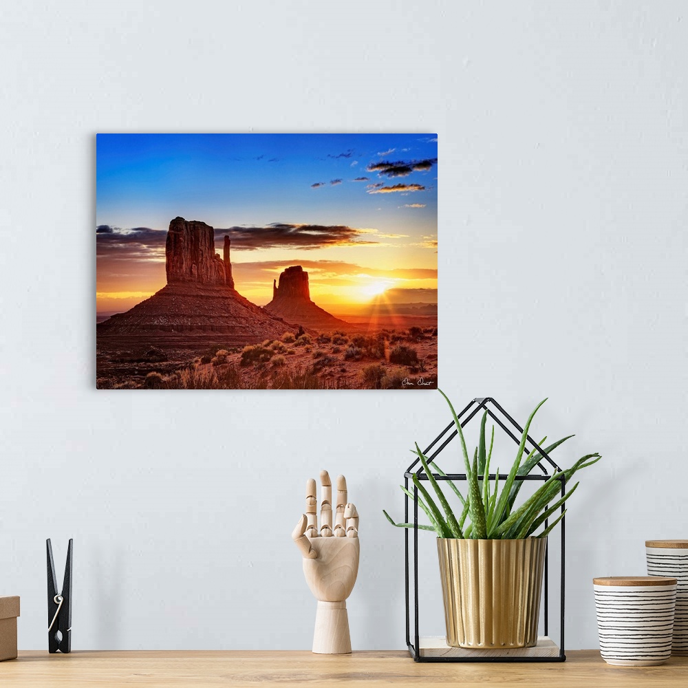 A bohemian room featuring Landscape photograph of the buttes at Monument Valley in Arizona with a bright sunset in the back...