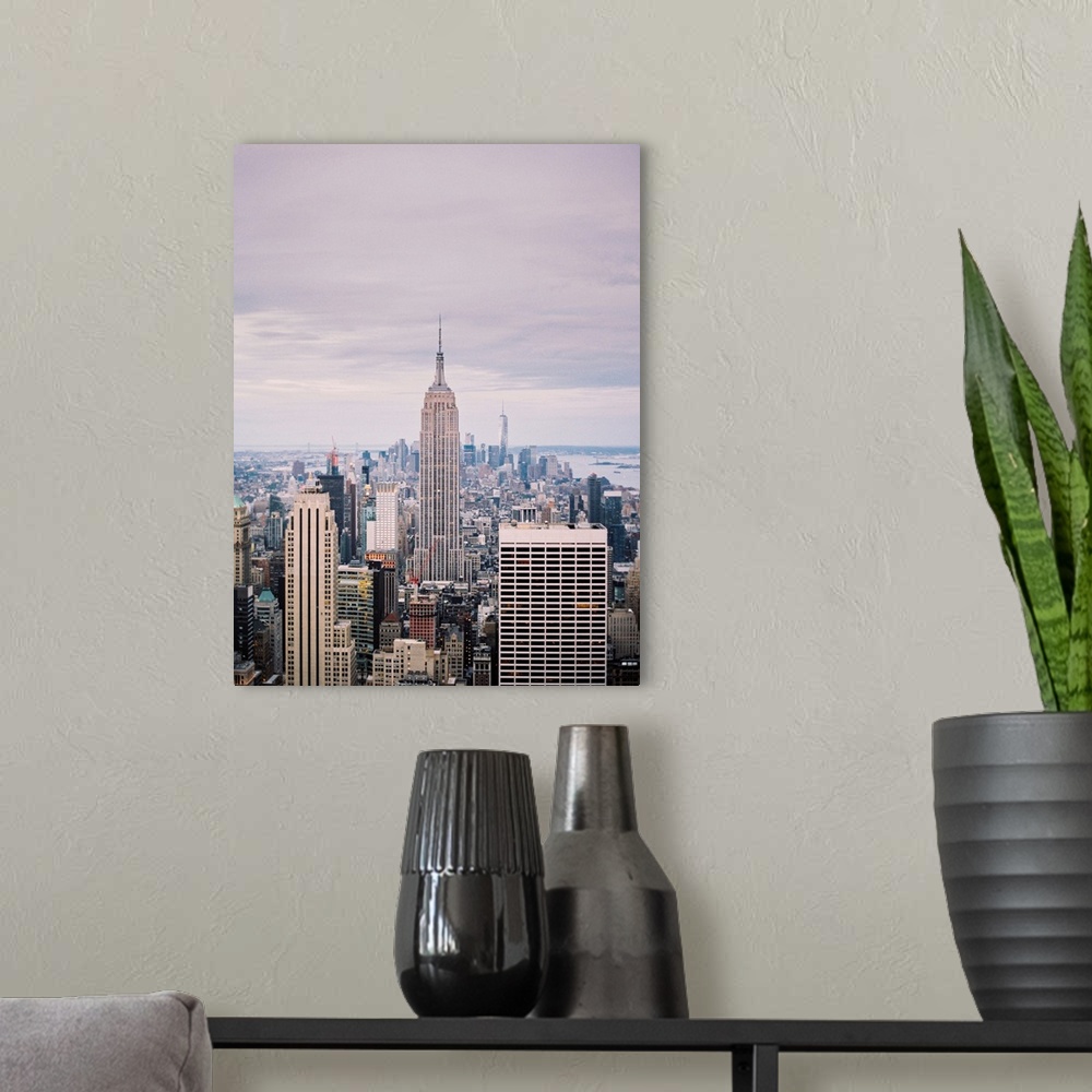 A modern room featuring Photograph of the Empire State Building and surrounding buildings, Manhattan, New York City.