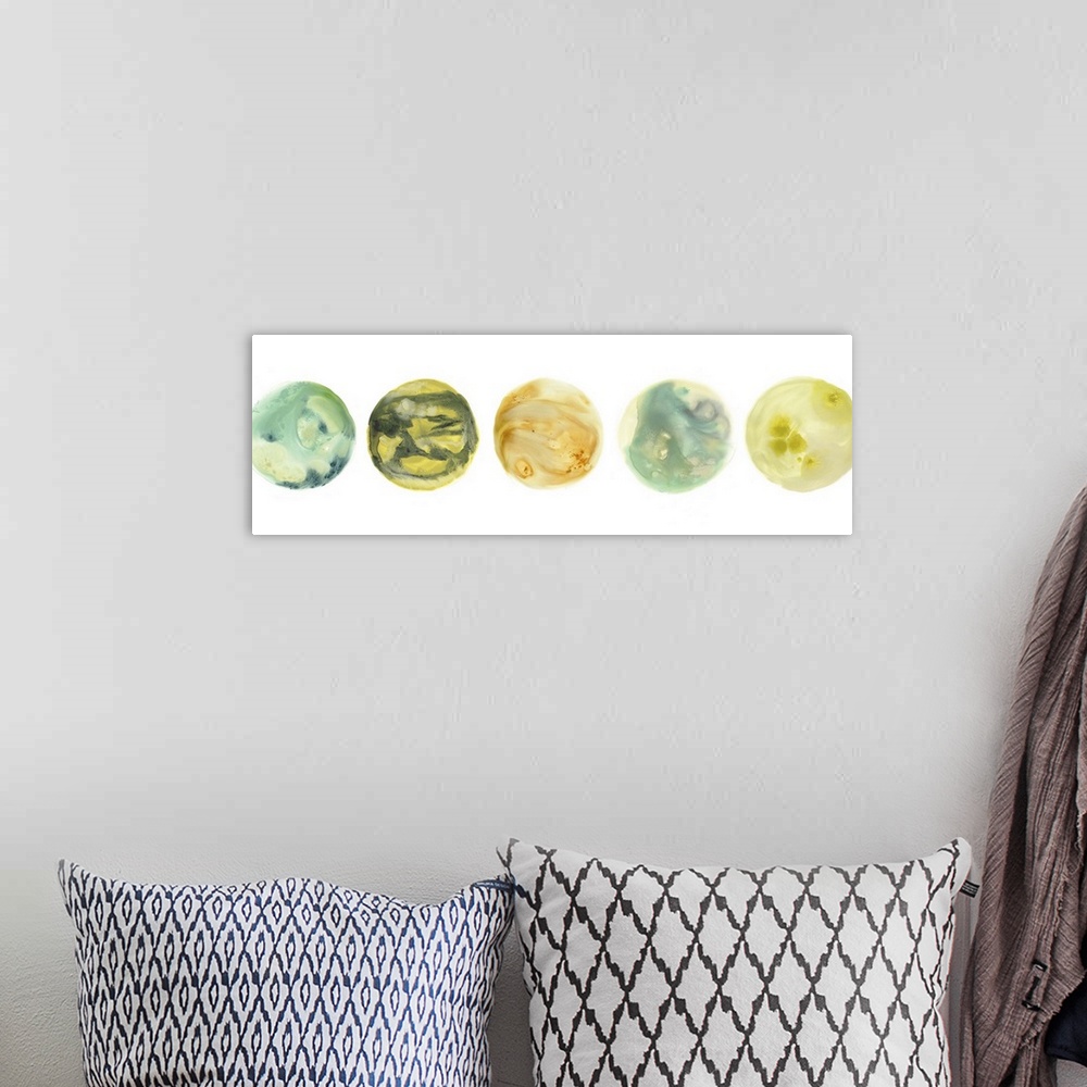 A bohemian room featuring Panoramic artwork of five circles with marbling colors representing planets, on a white background.