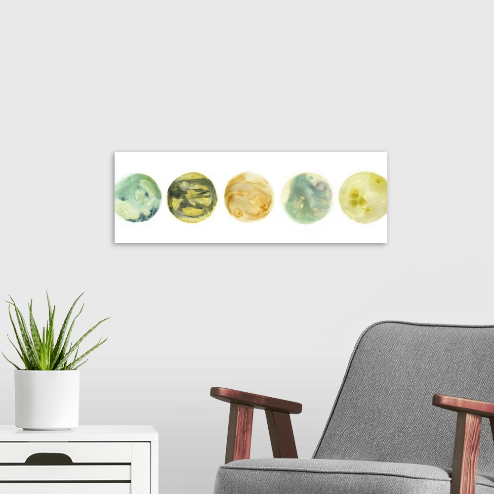 A modern room featuring Panoramic artwork of five circles with marbling colors representing planets, on a white background.