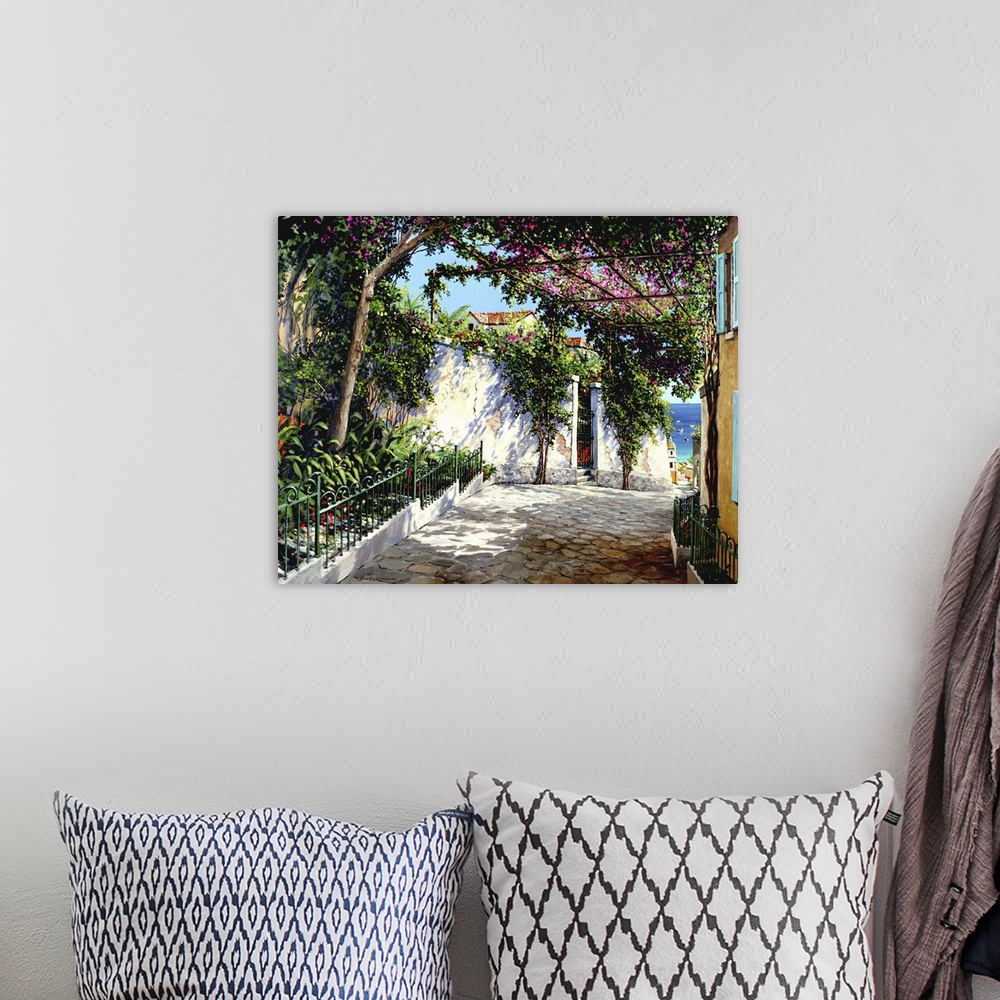 A bohemian room featuring Contemporary artwork of a street scene in the Italian town of Positano.