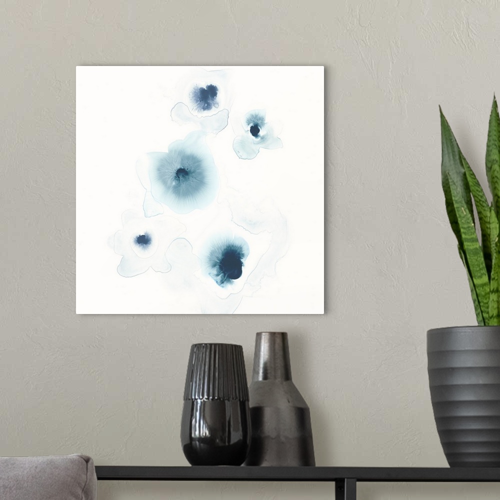 A modern room featuring Minimalist abstract artwork of blue watercolor spots on white.