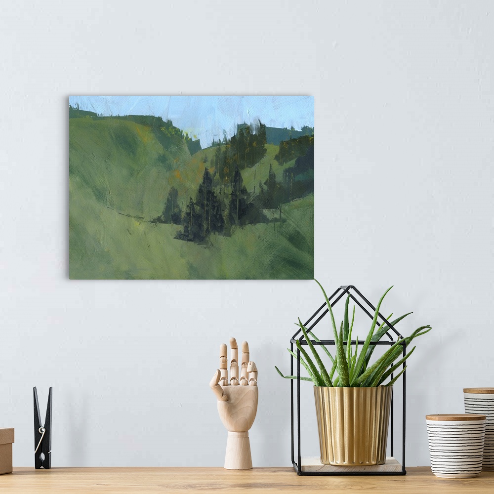 A bohemian room featuring Contemporary landscape painting with rolling hills and trees.