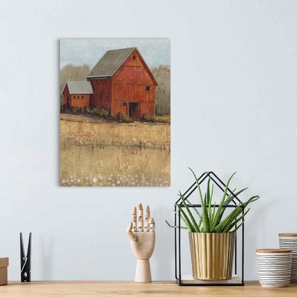 A bohemian room featuring Countryside artwork of rustic red house on a straw colored field.