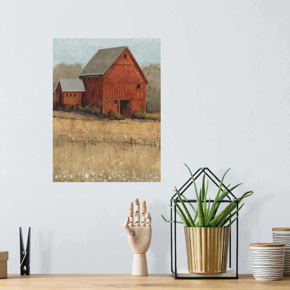 A bohemian room featuring Countryside artwork of rustic red house on a straw colored field.
