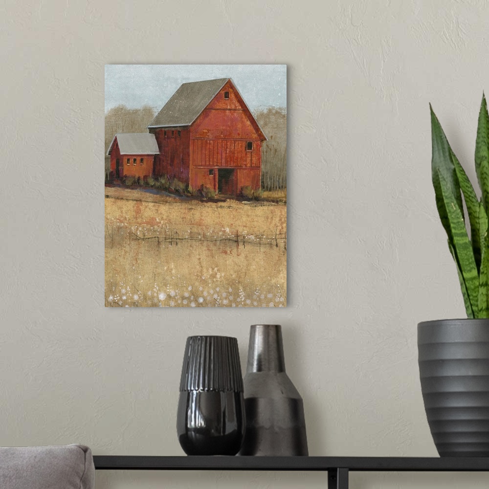 A modern room featuring Countryside artwork of rustic red house on a straw colored field.