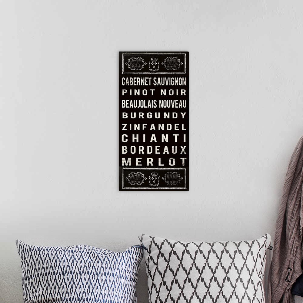 A bohemian room featuring Typography art in black and white of a list of red wines.