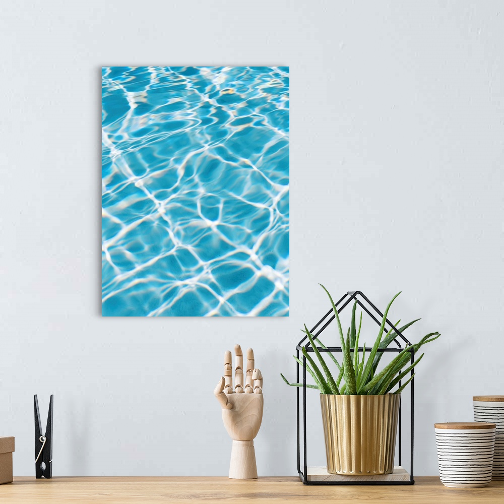 A bohemian room featuring An abstracted photograph of sunlight reflecting off of clear pool water.