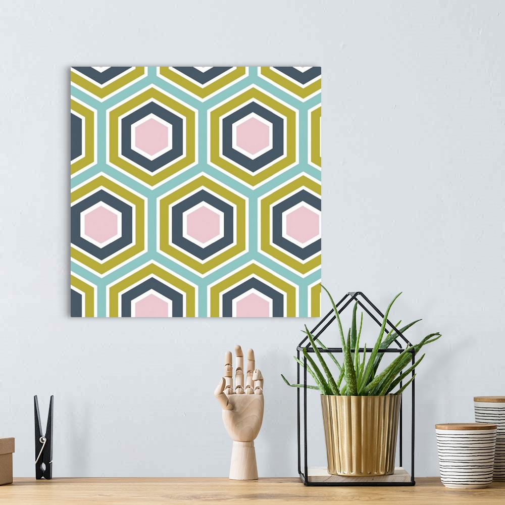 A bohemian room featuring Geometric artwork of hexagons in bright, summer tones.