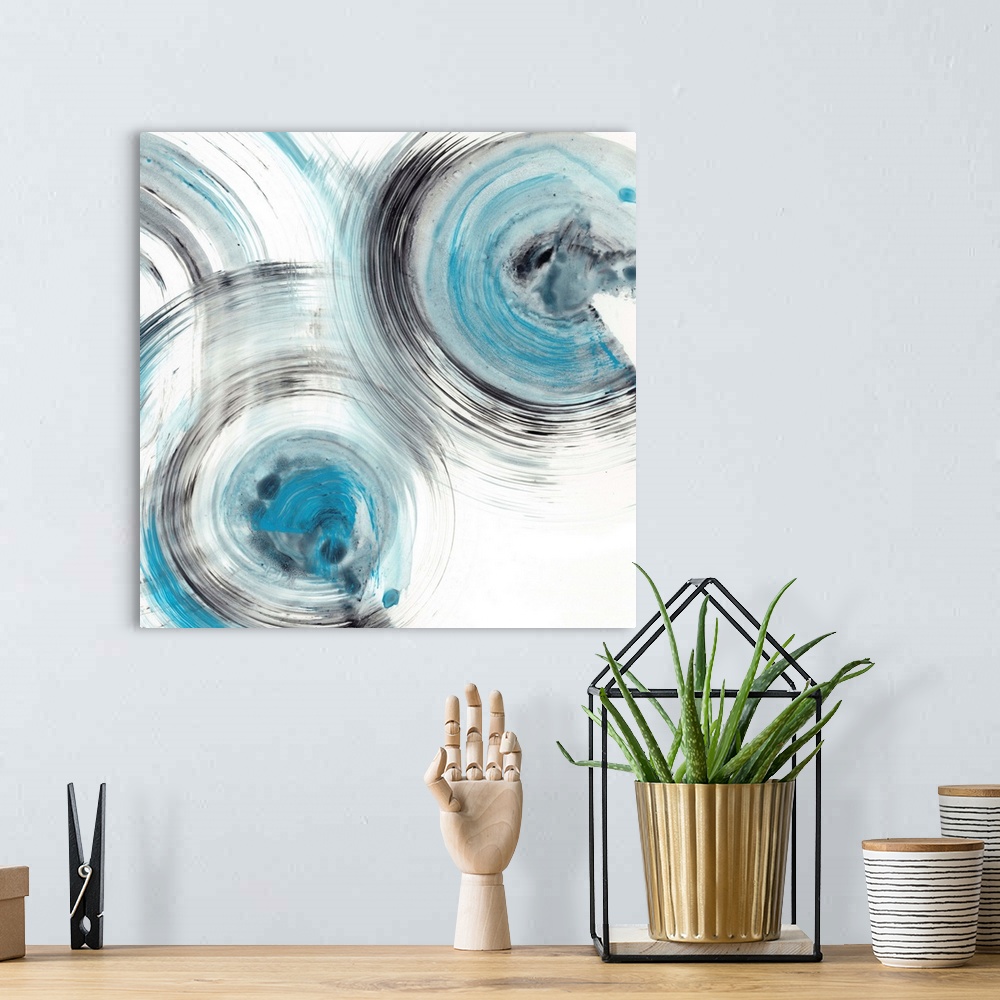 A bohemian room featuring Contemporary abstract painting of circular forms in blue and black reminiscent of the ripple effe...