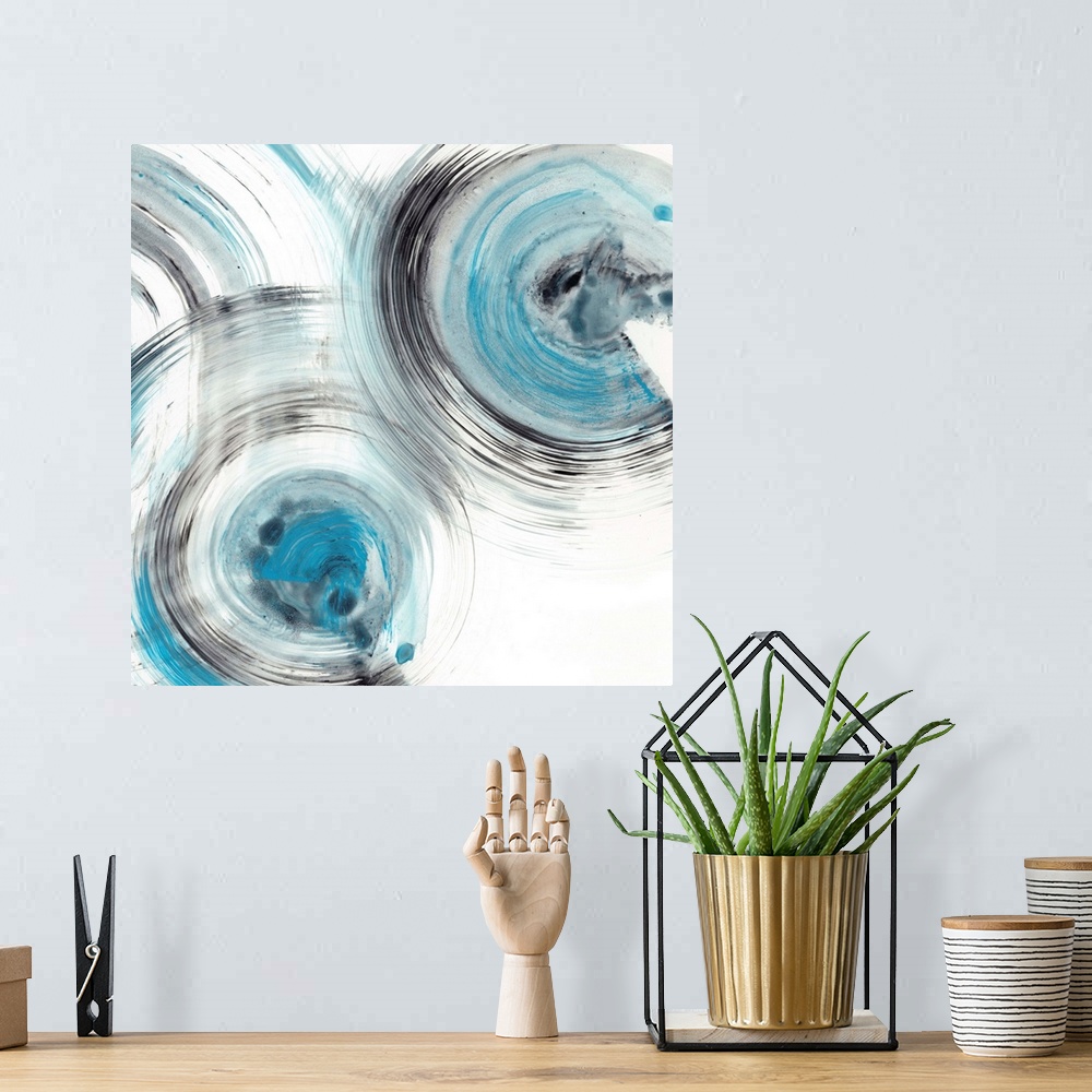 A bohemian room featuring Contemporary abstract painting of circular forms in blue and black reminiscent of the ripple effe...