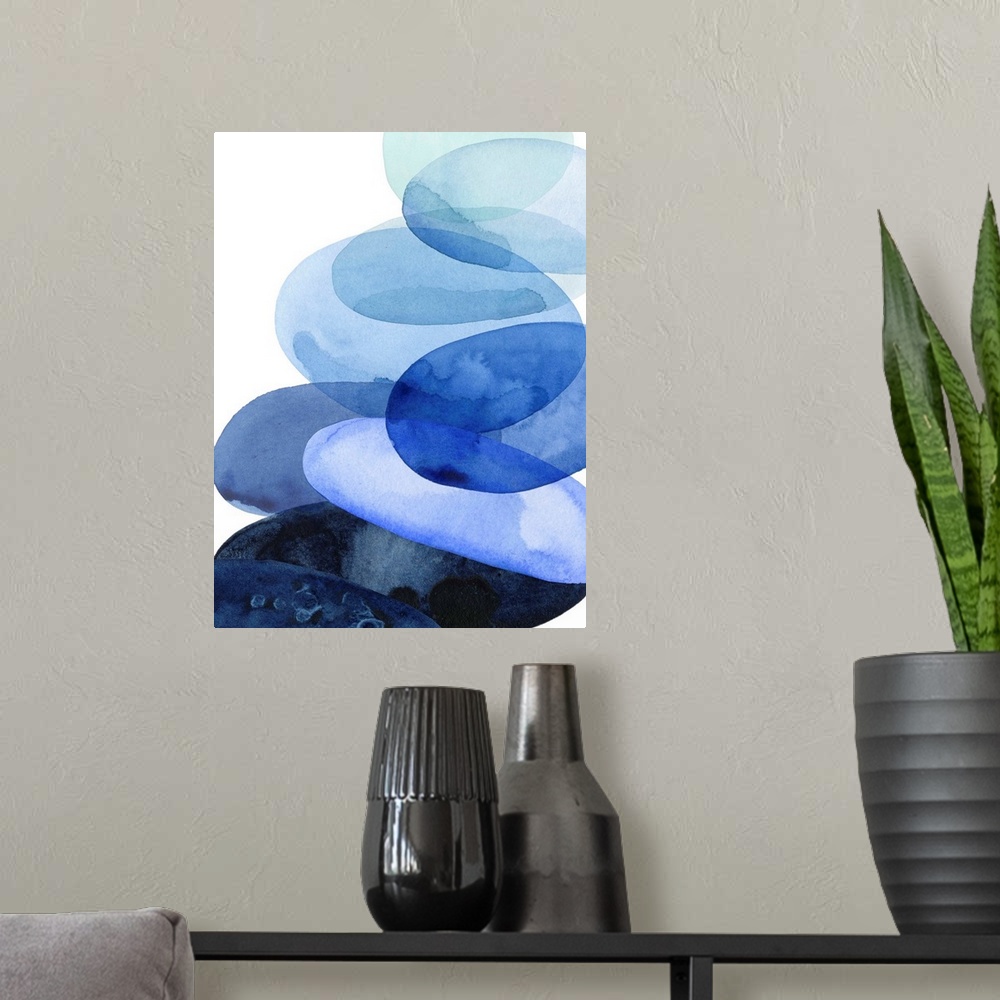 A modern room featuring Abstract watercolor painting of oval shapes, representing river stones, stacked on top of each ot...