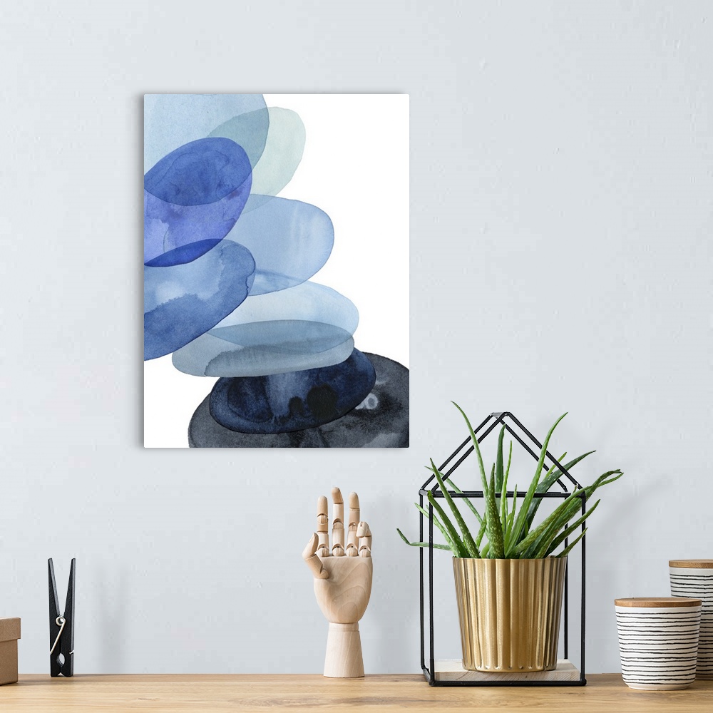 A bohemian room featuring Abstract watercolor painting of oval shapes, representing river stones, stacked on top of each ot...