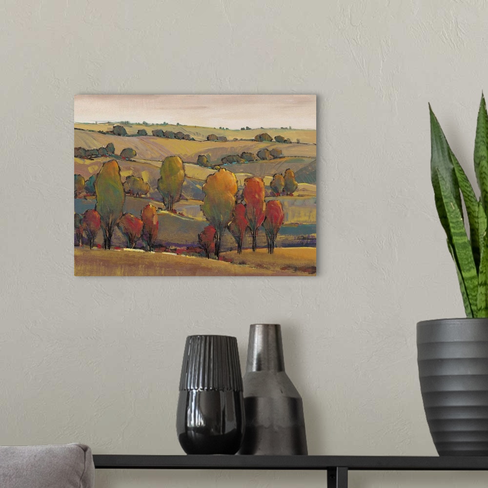 A modern room featuring A painting using dark muted tones of a serene landscape with rolling hills.