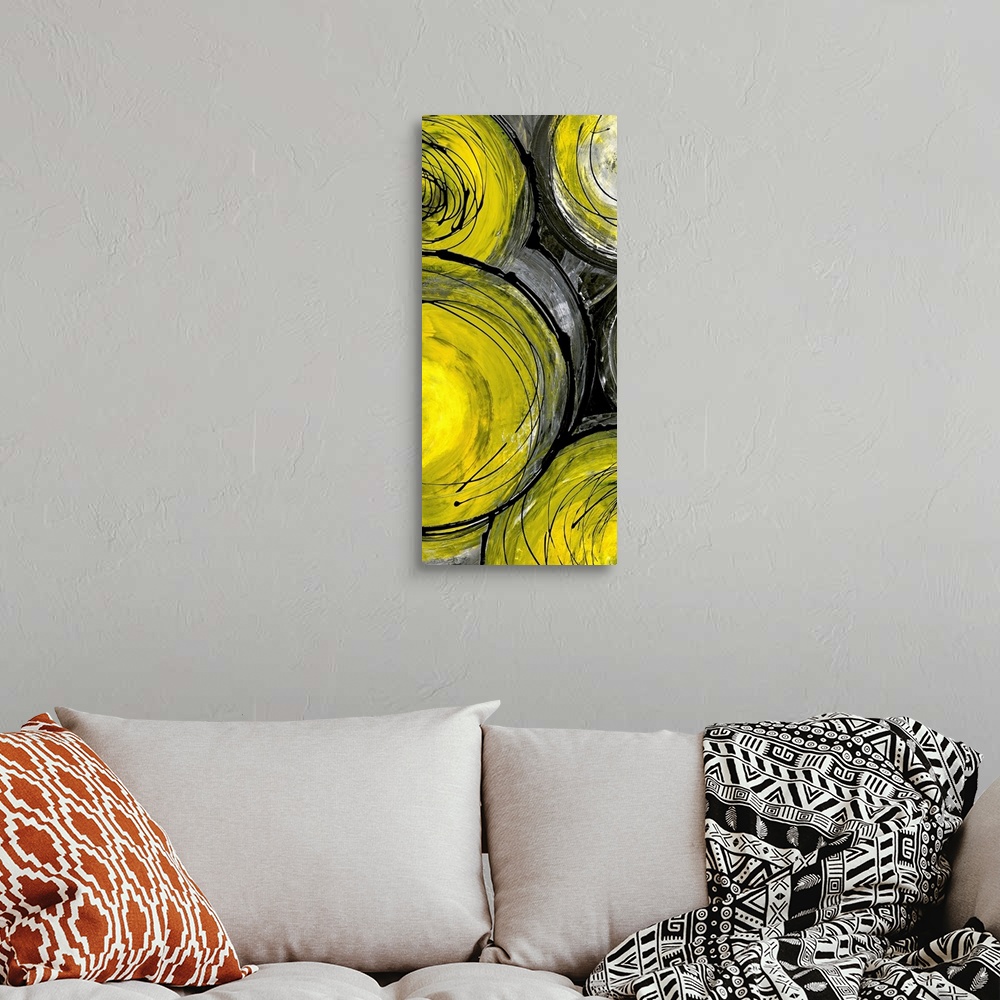 A bohemian room featuring Portrait painting on a large canvas of a grouping of yellow circles with circular scribbles throu...