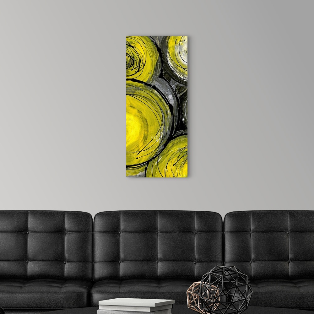 A modern room featuring Portrait painting on a large canvas of a grouping of yellow circles with circular scribbles throu...