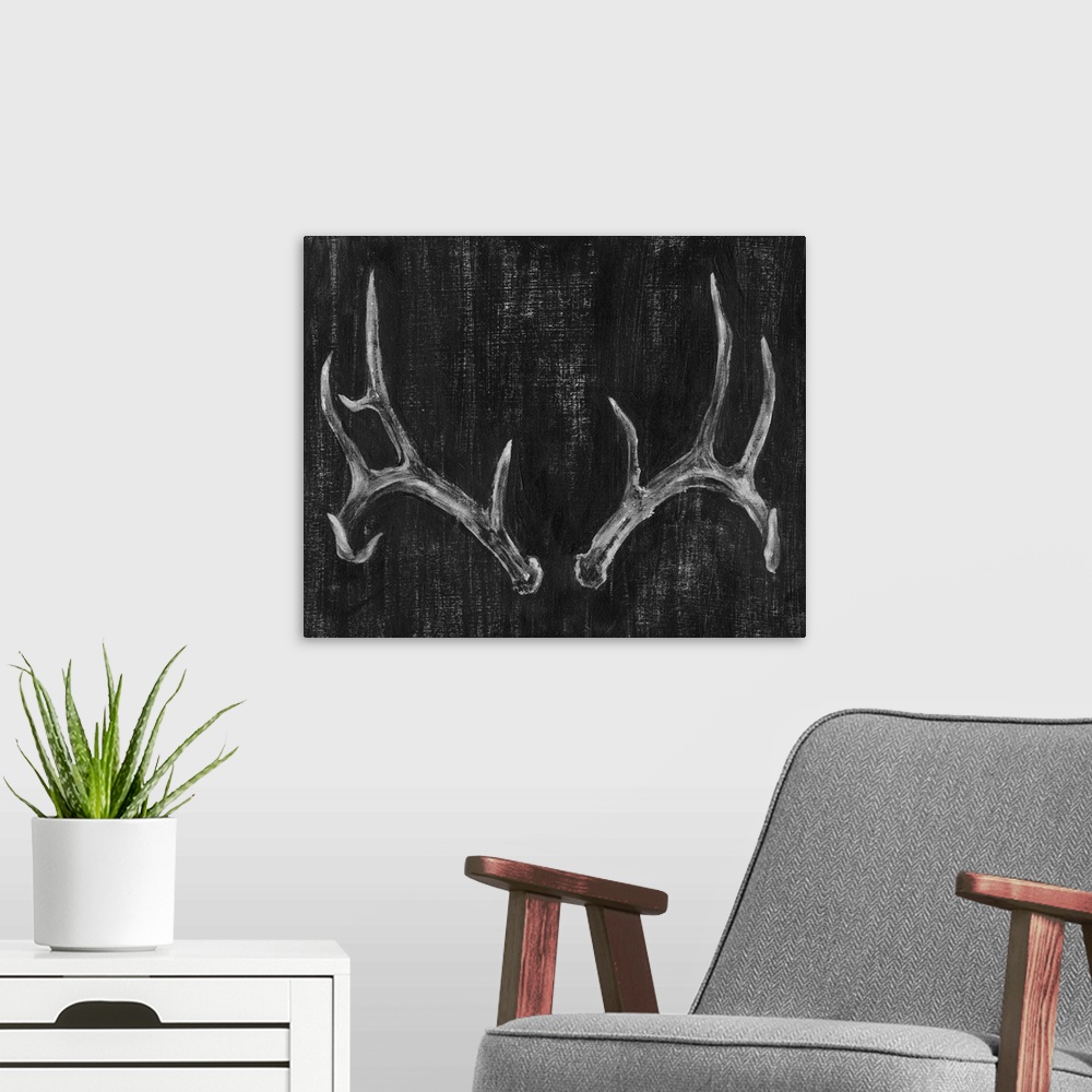 A modern room featuring Contemporary artwork of a set of large pronged antlers.
