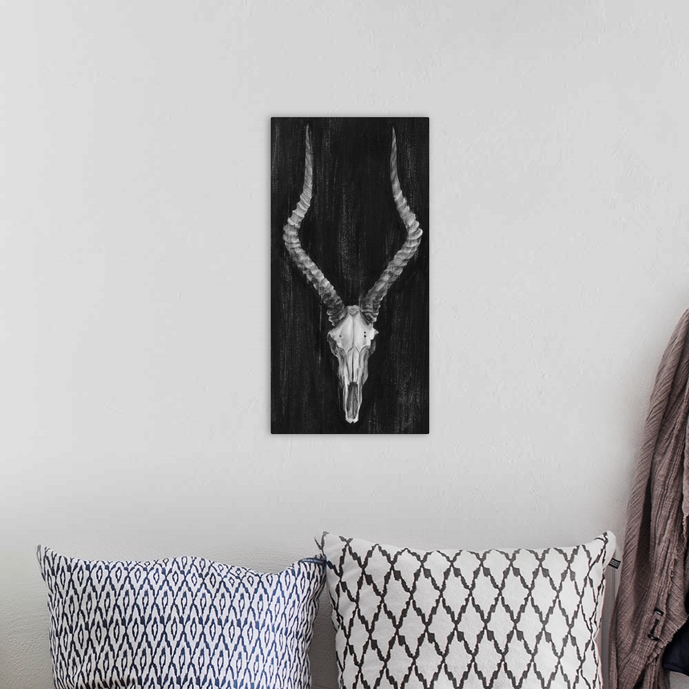 A bohemian room featuring Contemporary artwork of an antelope skull with large horns.