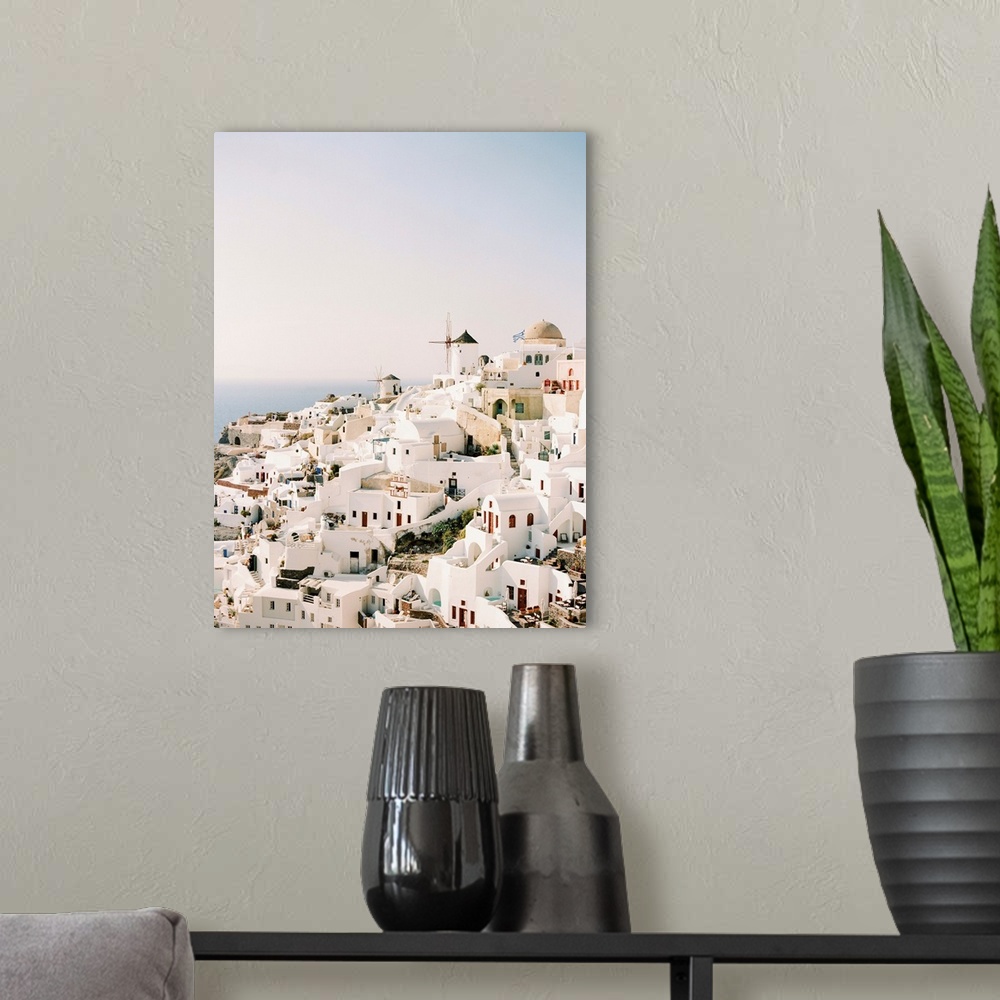 A modern room featuring A photograph of the iconic white stucco buildings and windmills that are characteristic of the hi...