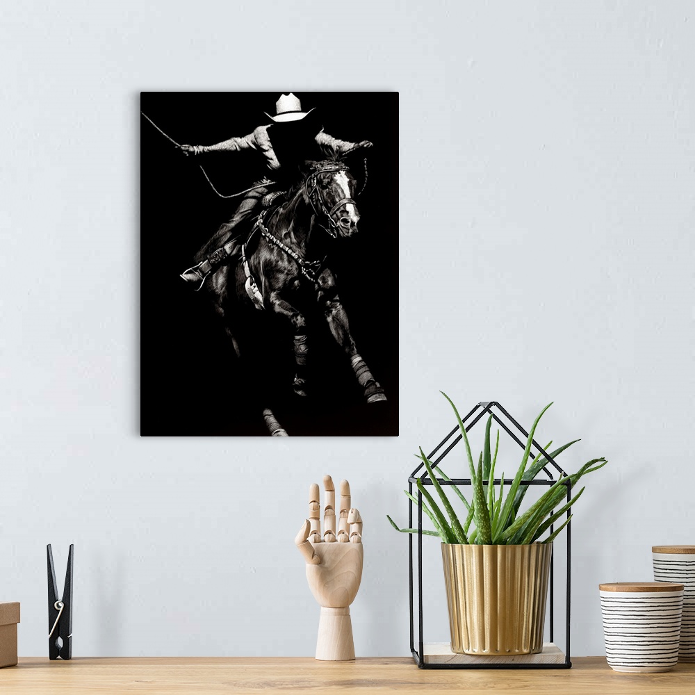 A bohemian room featuring Black and white lifelike illustration of a cowboy riding a horse.