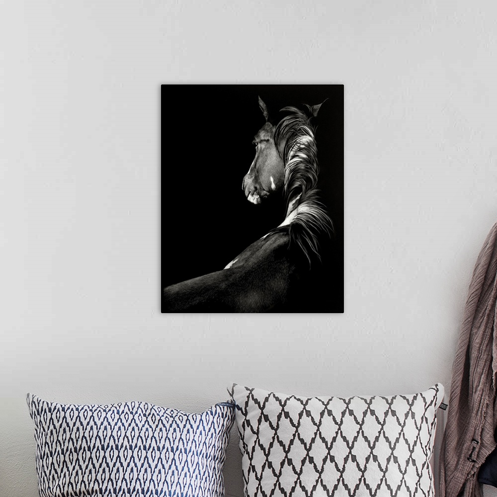 A bohemian room featuring Black and white illustration of a horse seen from the back.