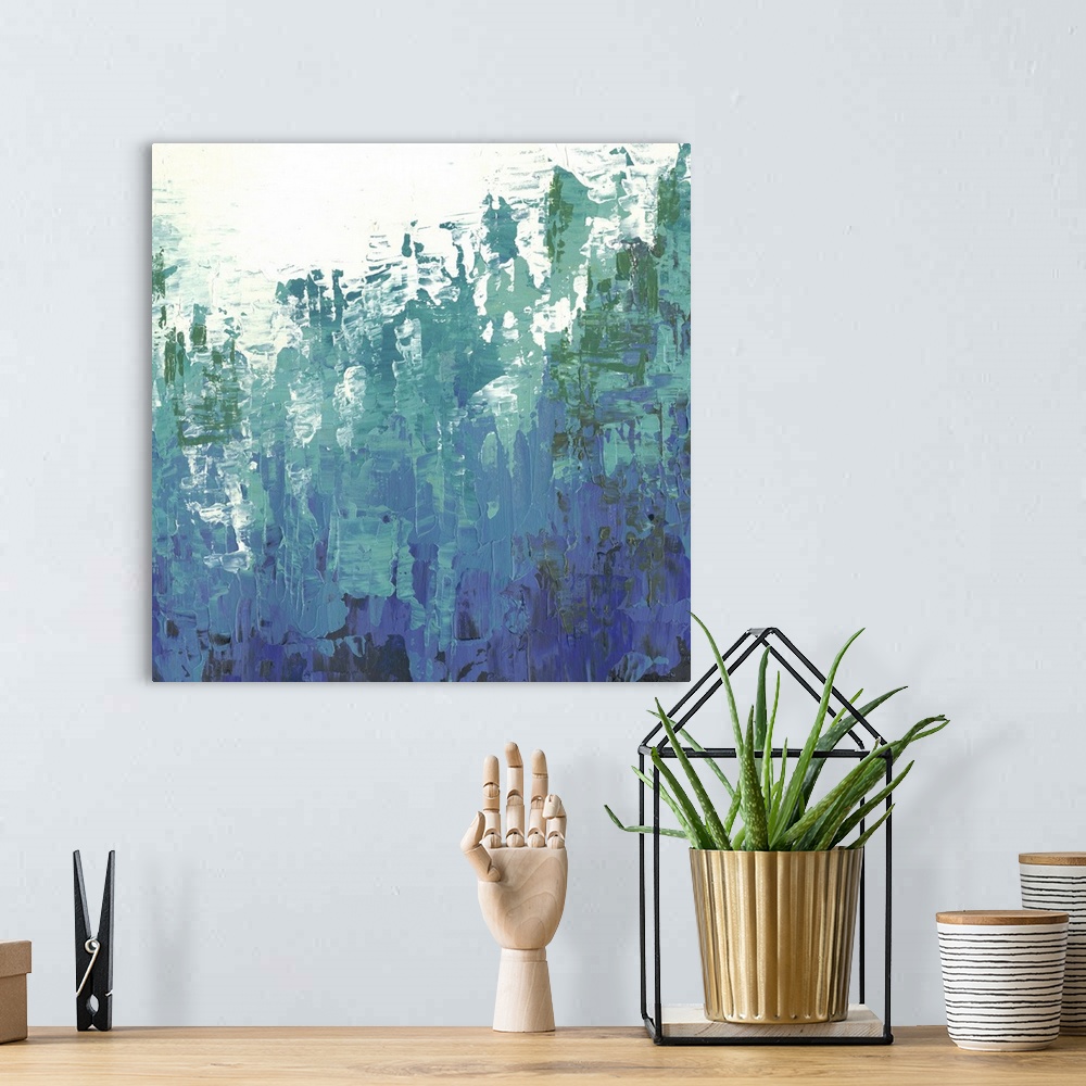 A bohemian room featuring Abstract art with deep blue and green colors rising upward overtaking the negative space at the top.