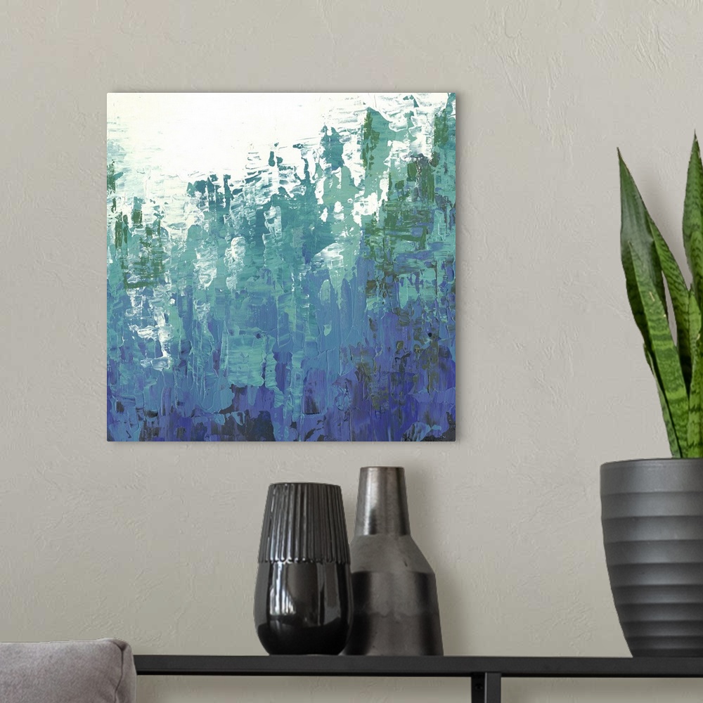 A modern room featuring Abstract art with deep blue and green colors rising upward overtaking the negative space at the top.