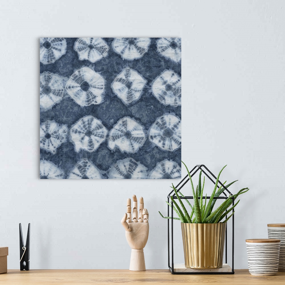 A bohemian room featuring Artistic design of rows of a tie-dye pattern in white on a blue background.