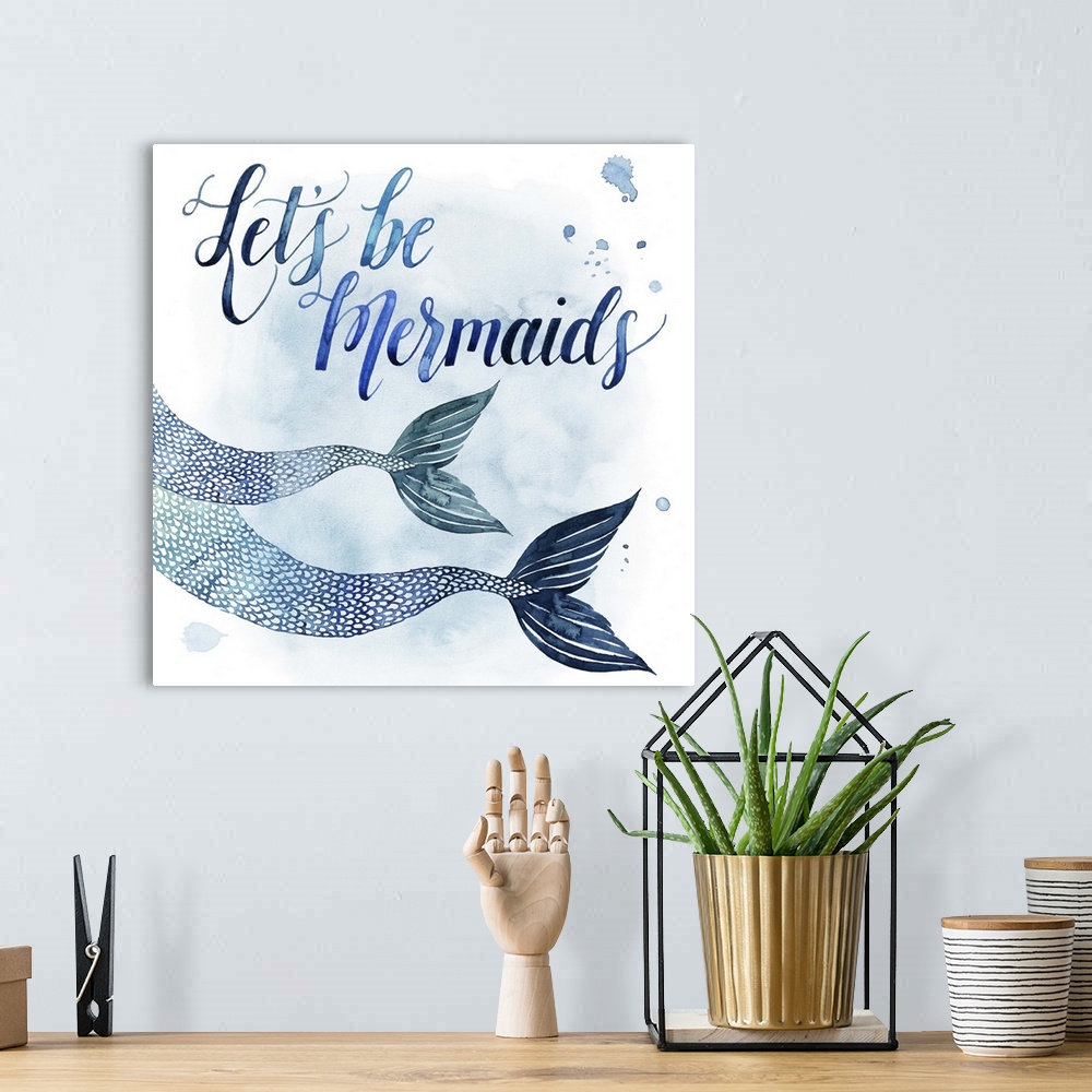 A bohemian room featuring Square beach themed decor with painted mermaid fins and the phrase "Let's Be Mermaids" all in sha...