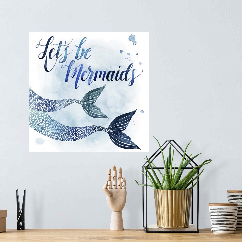 A bohemian room featuring Square beach themed decor with painted mermaid fins and the phrase "Let's Be Mermaids" all in sha...