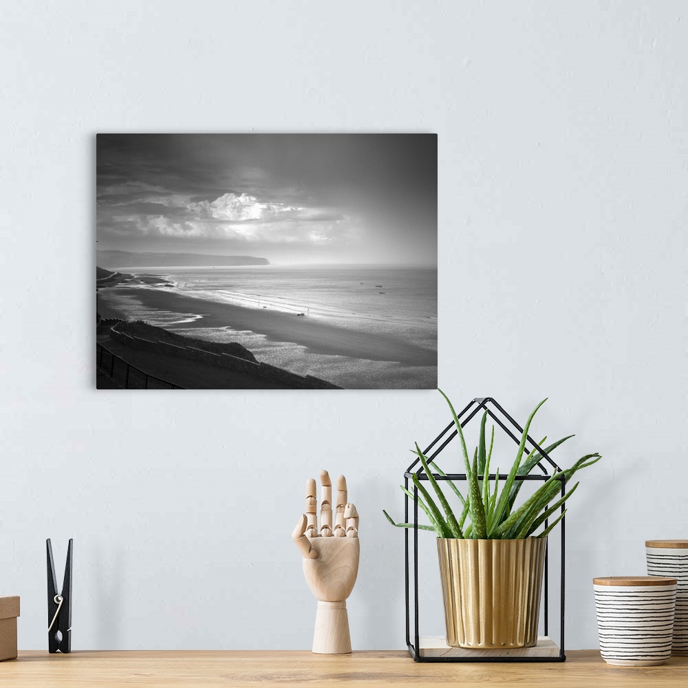 A bohemian room featuring Fine art photo of a seascape under a stormy sky.