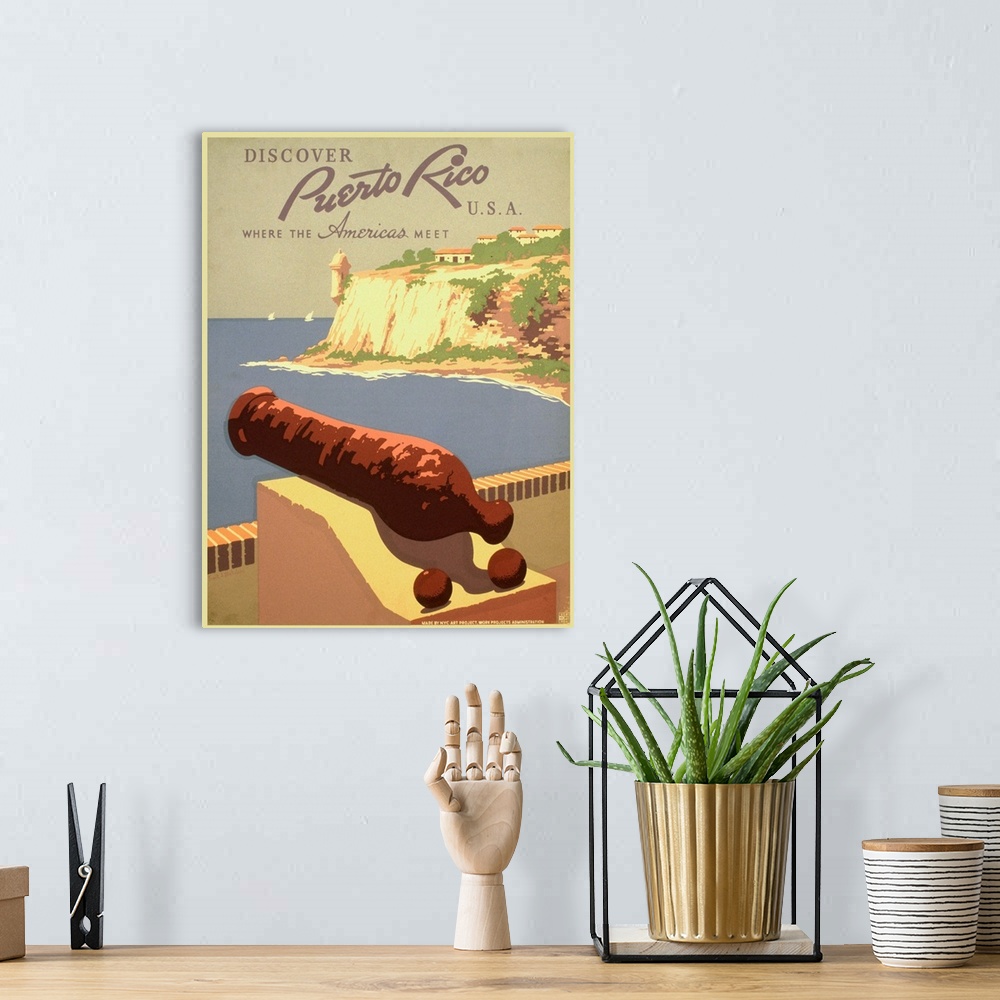 A bohemian room featuring Vintage travel poster advertising Puerto Rico, with a cannon overlooking the ocean.