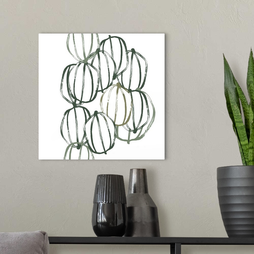 A modern room featuring Square contemporary artwork of seed pods in shades of green over a white background.
