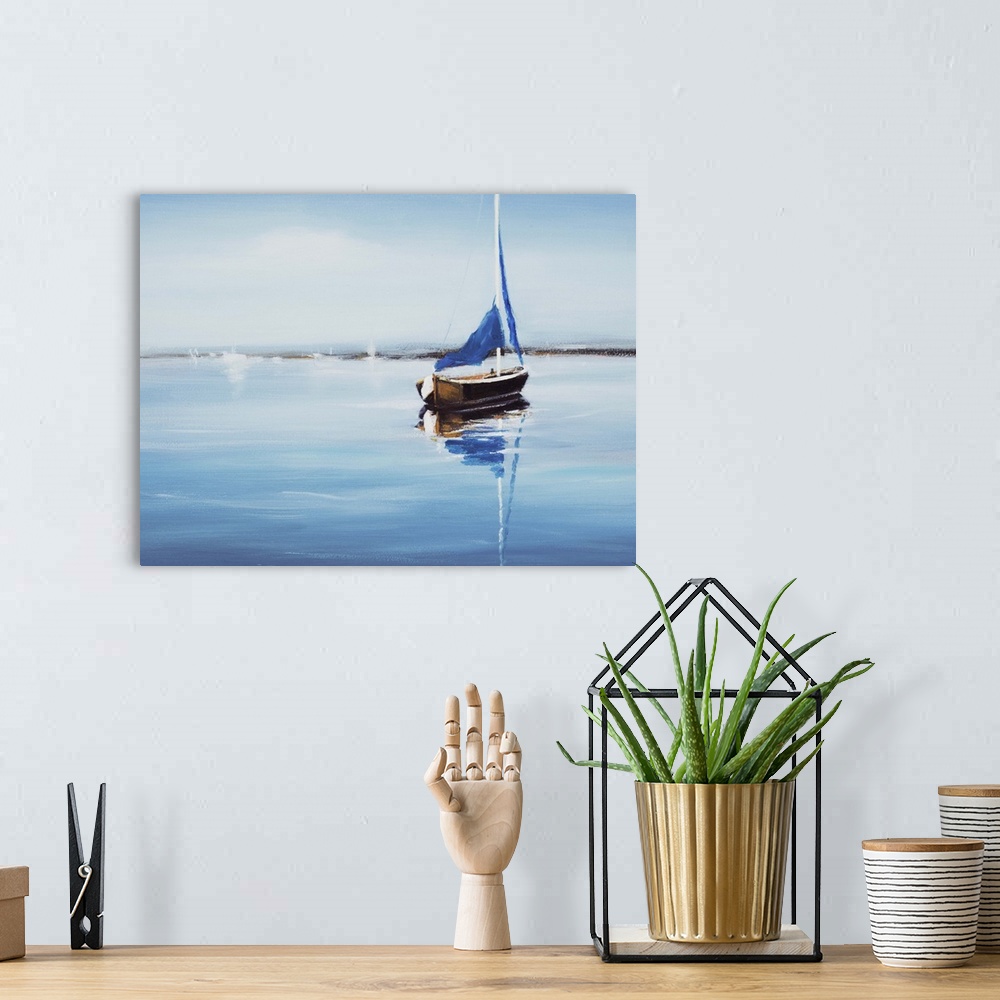 A bohemian room featuring Contemporary art print of a sail boat on crystal blue water.