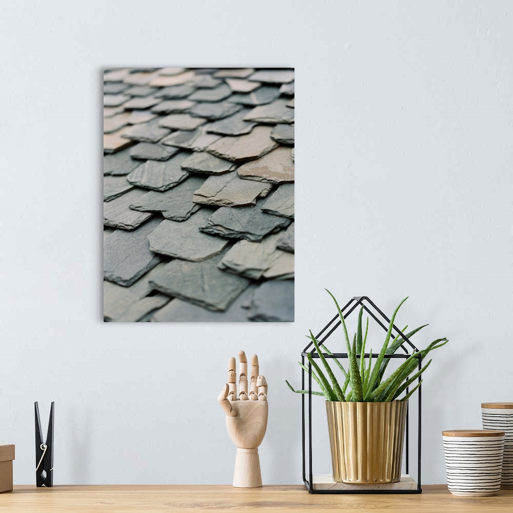 A bohemian room featuring A close up photograph of hand-hewn stone slates on a rustic roof.