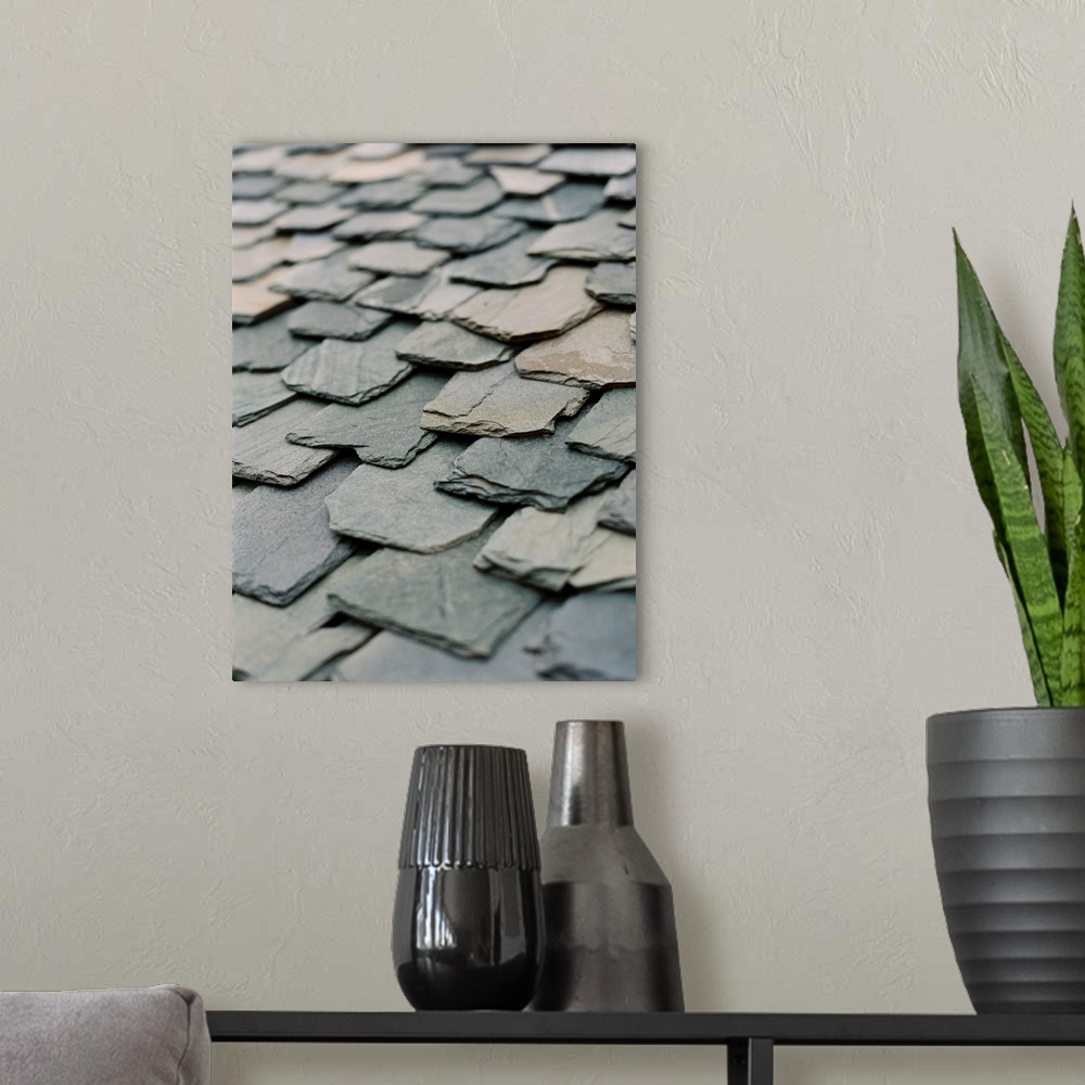 A modern room featuring A close up photograph of hand-hewn stone slates on a rustic roof.