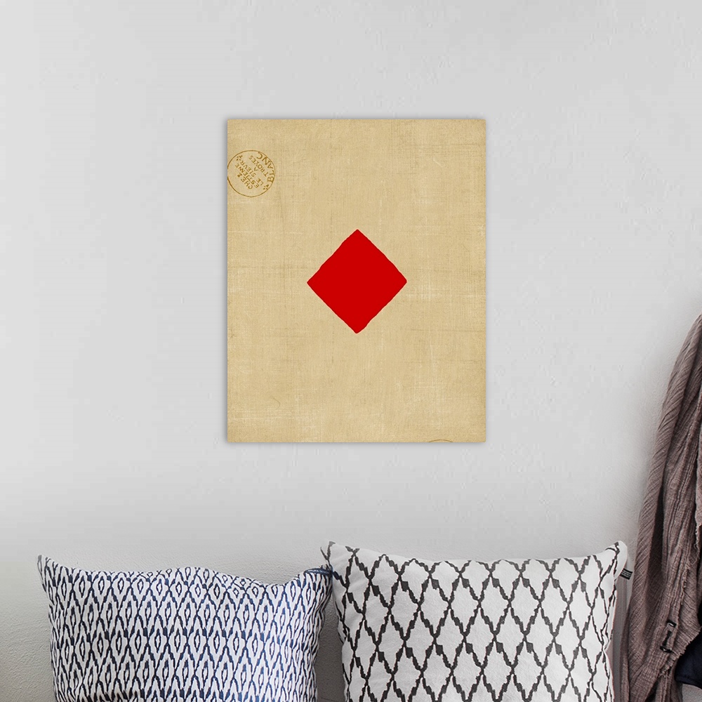 A bohemian room featuring Contemporary artwork resembling a giant playing card with two stamp emblems.