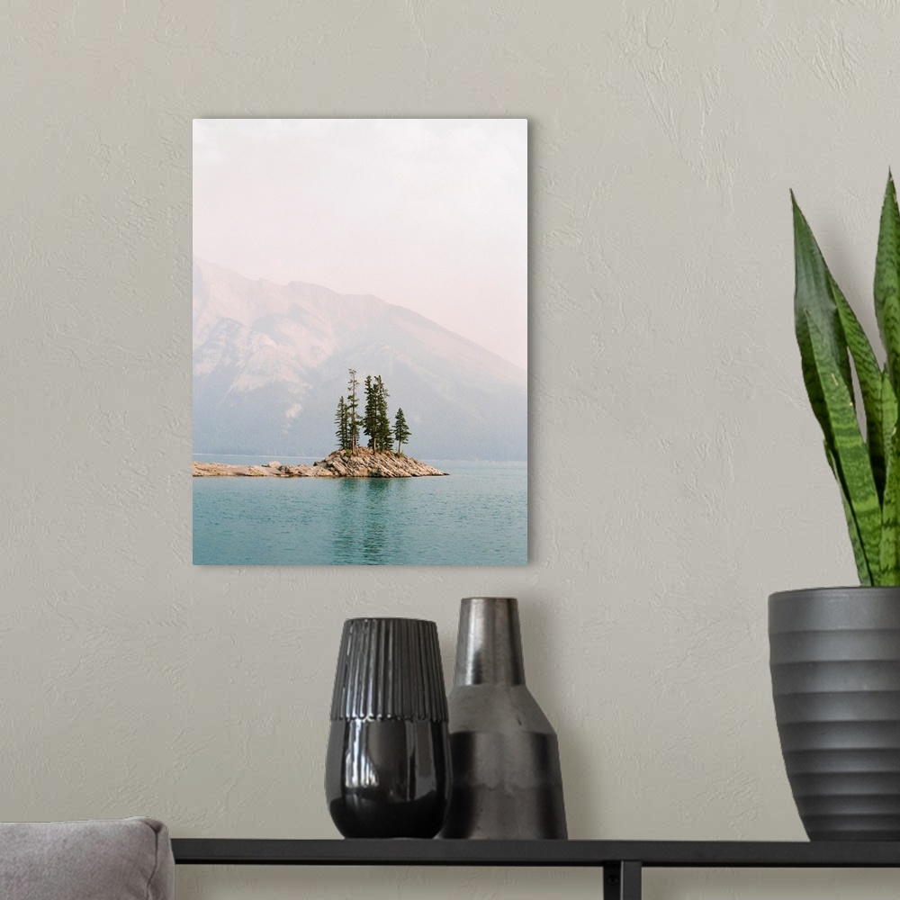A modern room featuring Photograph of several trees on a small island under a hazy sky, Banff, Canada.