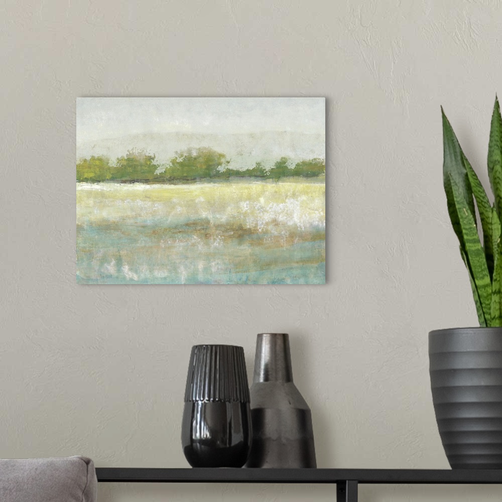 A modern room featuring Contemporary landscape painting of a meadow with green trees along the edge.