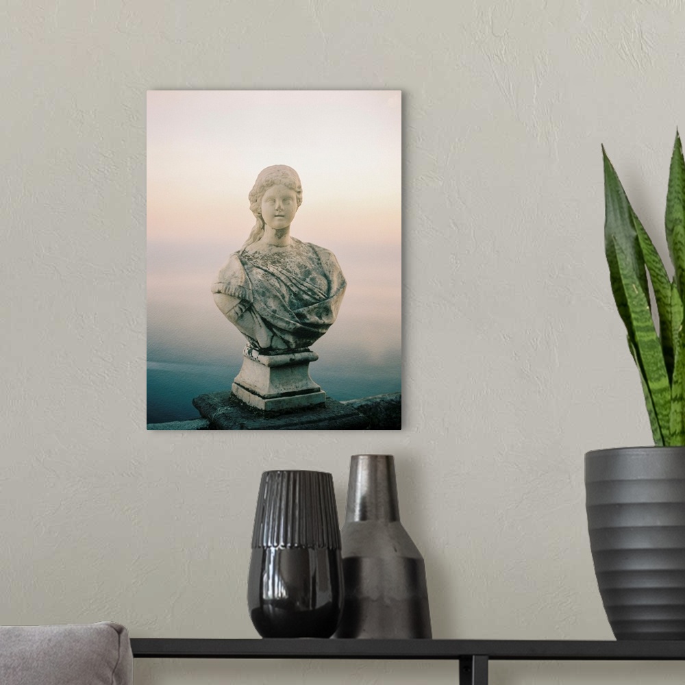 A modern room featuring A photograph of a simple, classic bust statue on a stone railing, Lake Como, Italy.