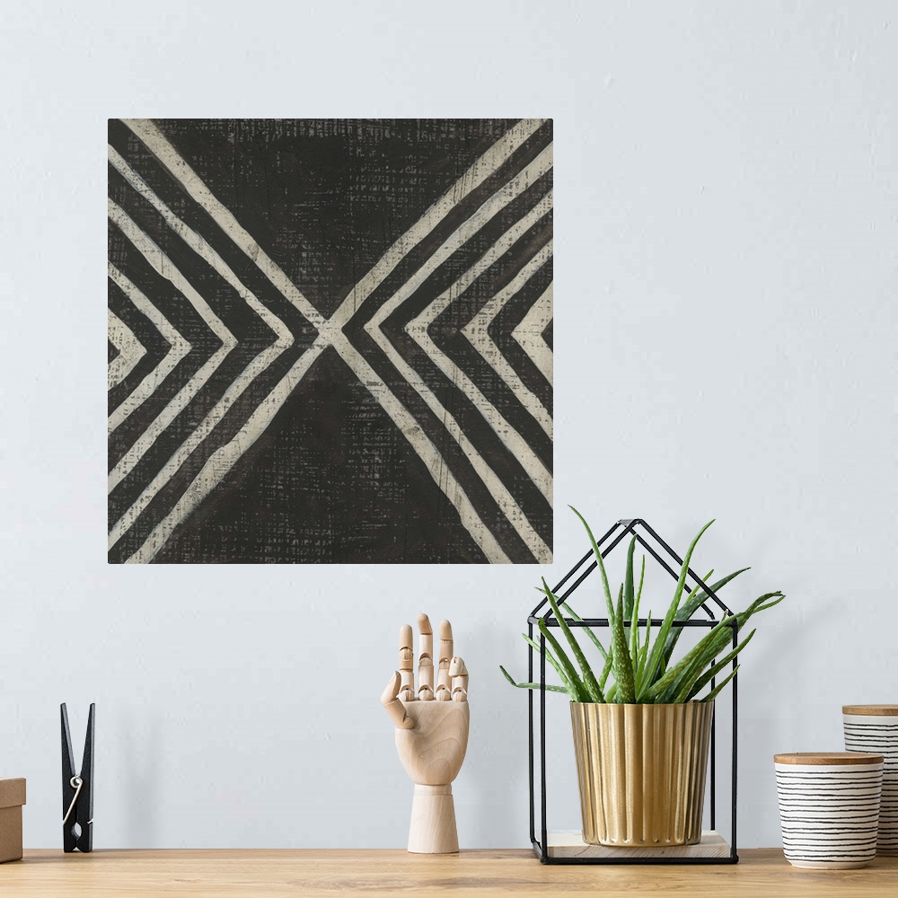 A bohemian room featuring This decorative artwork features a black and white pattern in a hand painted style with a distres...